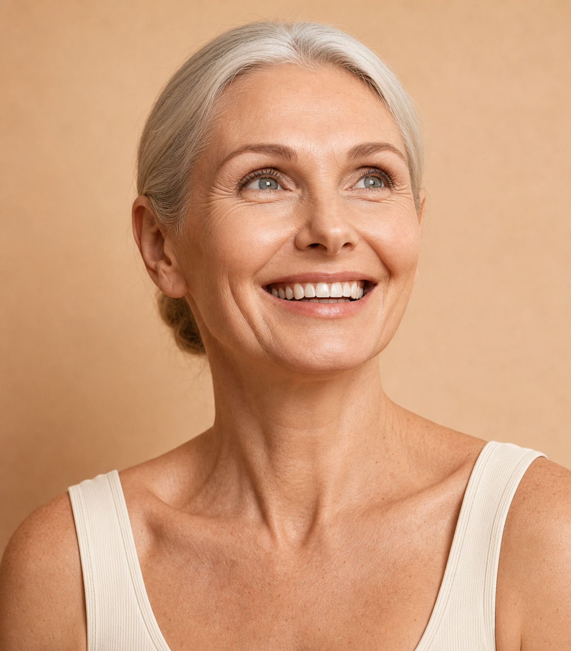 Older adult smiling against a warm background