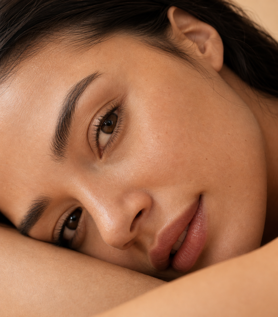 Adult resting with their face turned toward camera